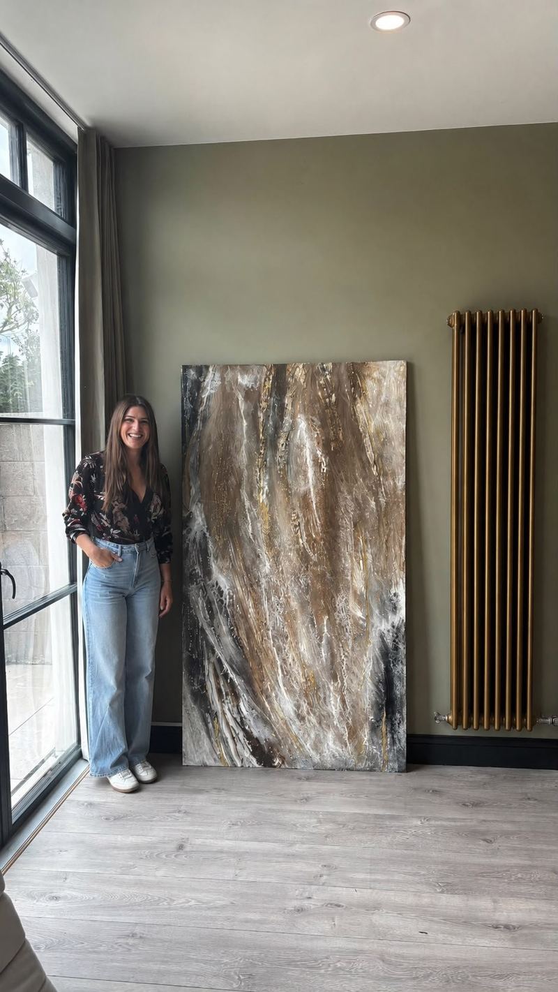 Cristina Luque beside one of her large-format texture paintings